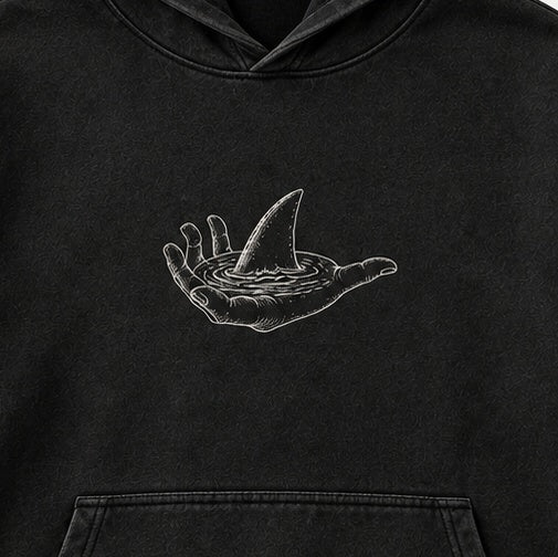 Hand and shark fin artwork detail — crop of the digital concept mockup.